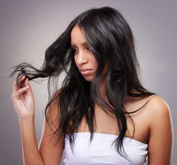 female-looks-at-her-long-hair